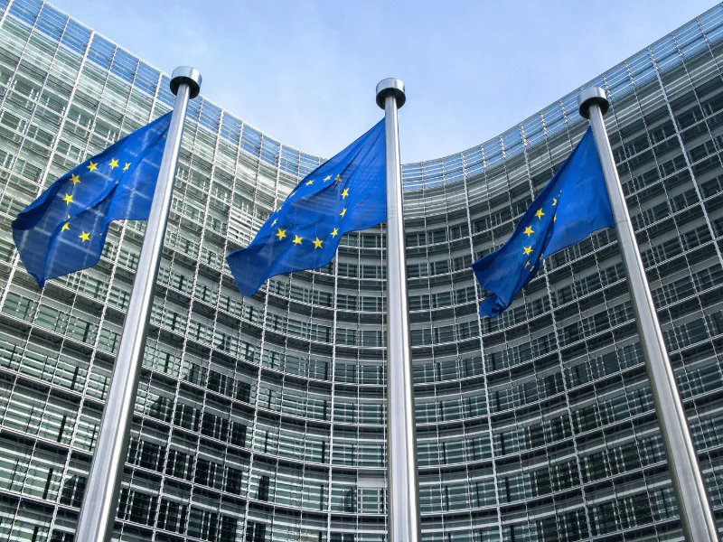 European Union flags flying in front of the European Commission headquarters in Brussels