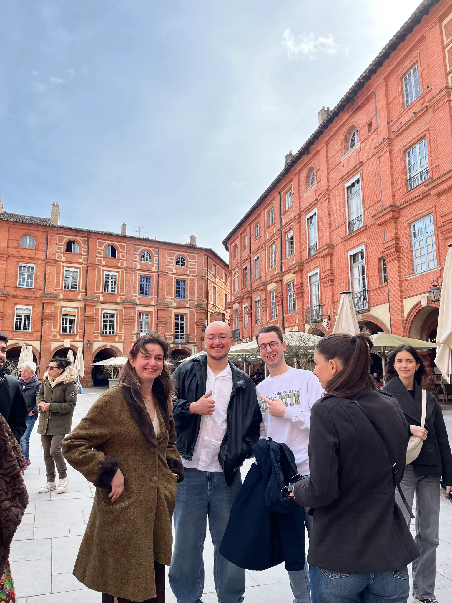 AEGEE Toulouse members gathered under the brick arcades of the Place du Capitole