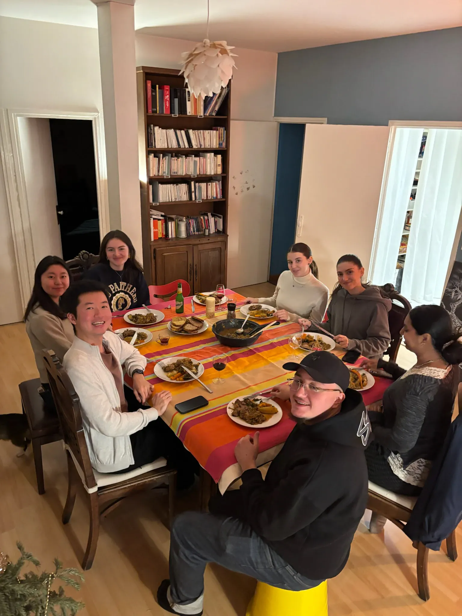 A large group seated around a table for a home-cooked Moroccan dinner