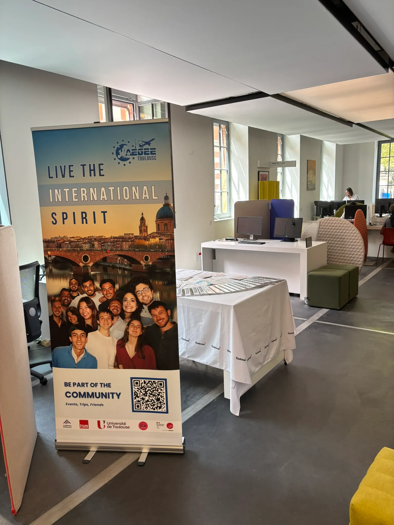 An information banner and table set up in a shared office space
