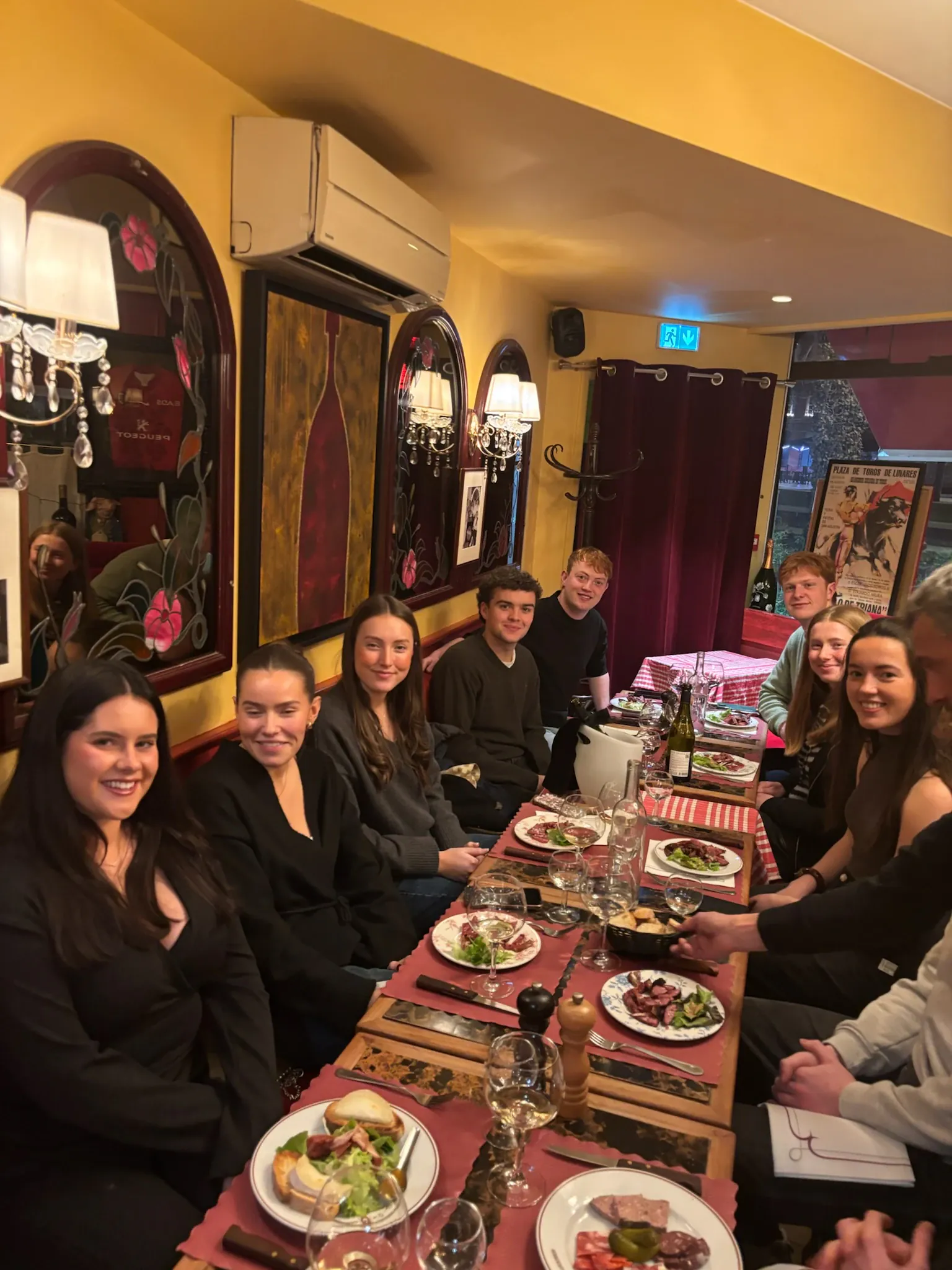 AEGEE Toulouse members sharing a meal around a long restaurant table