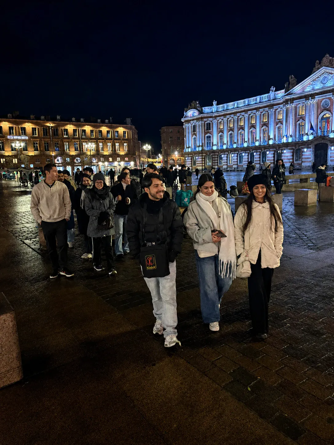 AEGEE Toulouse members in front of the floodlit Capitole at dusk